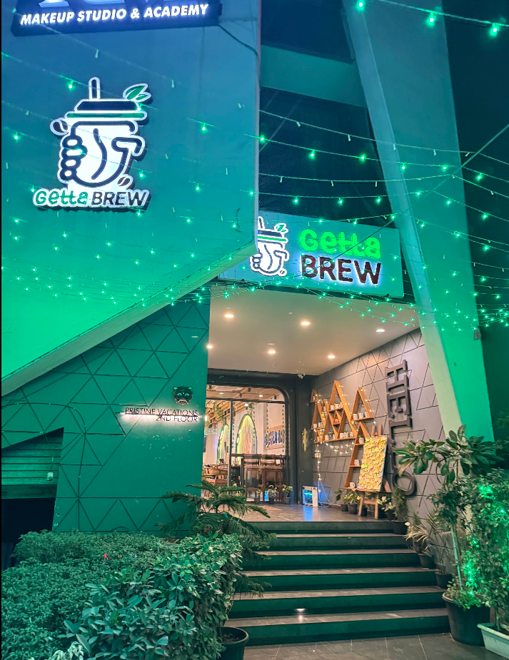Getta Brew storefront lit up in green string lights